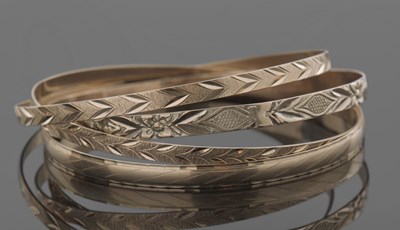 Lot 398 - Three hallmarked 9ct gold bangles, and one...