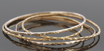 Lot 403 - Four yellow metal unmarked bangles, 25.2gms