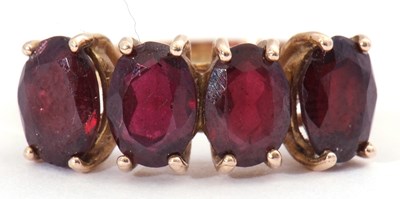 Lot 46 - Garnet four stone ring, a row of uniform oval...