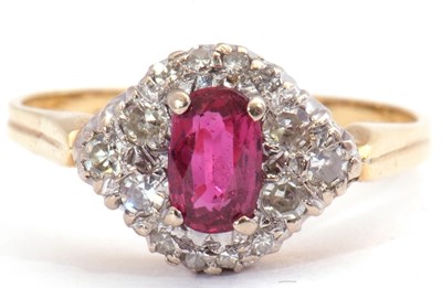 Lot 80 - Ruby and diamond ring centring an oval cut...