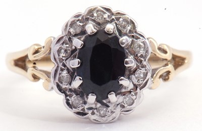 Lot 100 - 9ct gold, dark sapphire and diamond cluster...