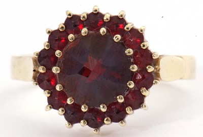 Lot 101 - Garnet cluster ring, the large round cut...