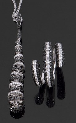 Lot 390 - 18ct white gold black and white diamond ring...