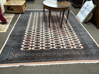 Lot 622 - A 20th Century Bokhara type machine made floor...