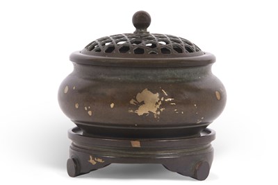 Lot 156 - A Chinese bronze gilt gold splashed censer on...